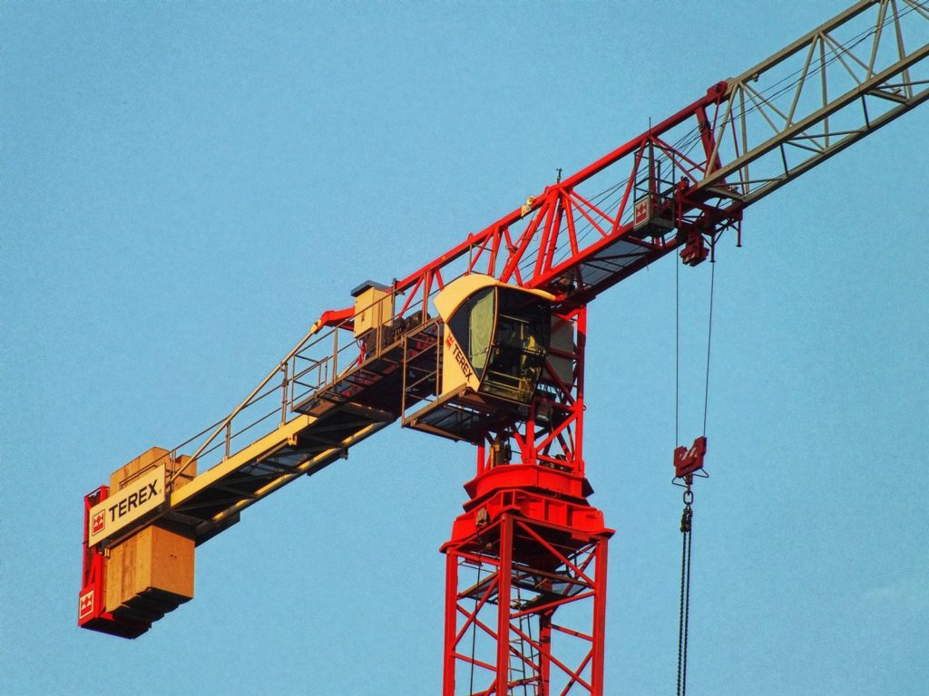 red and white metal Terex crane during daytime
